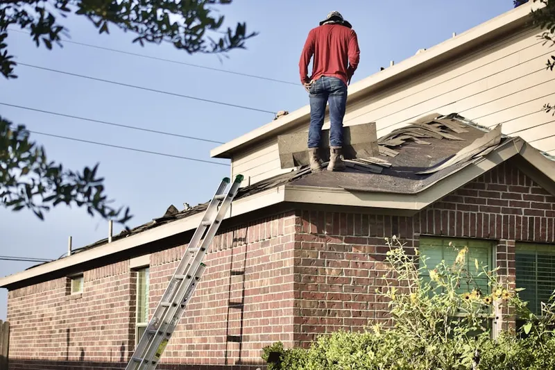 Professional roofer working on a residential roof in Plumb Point